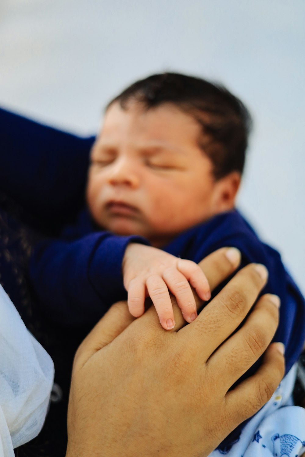 a woman holding a baby in her arms