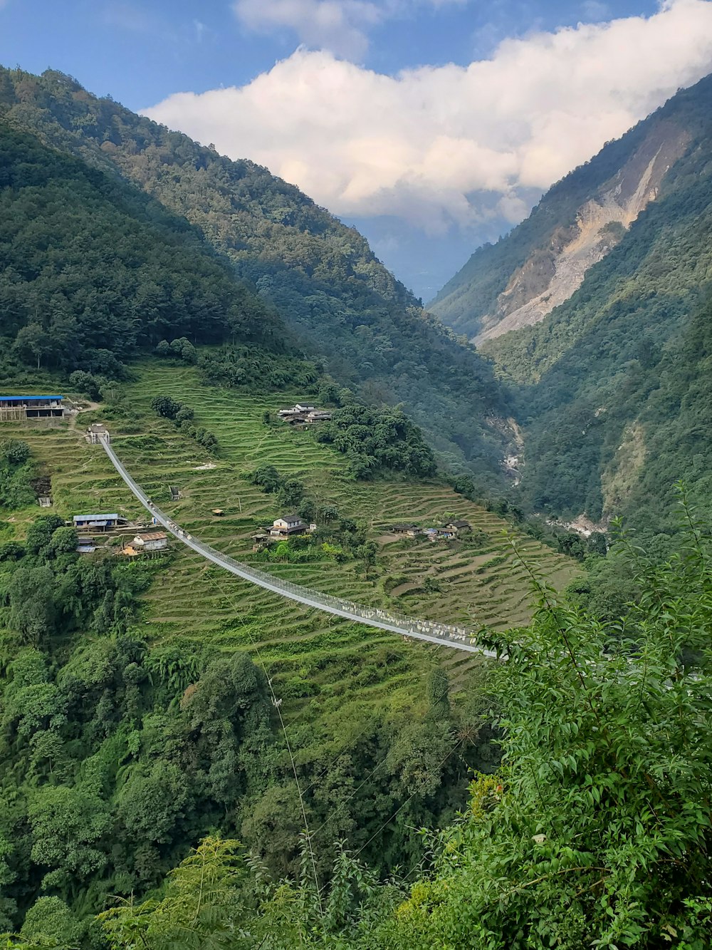 a scenic view of a winding road in the mountains