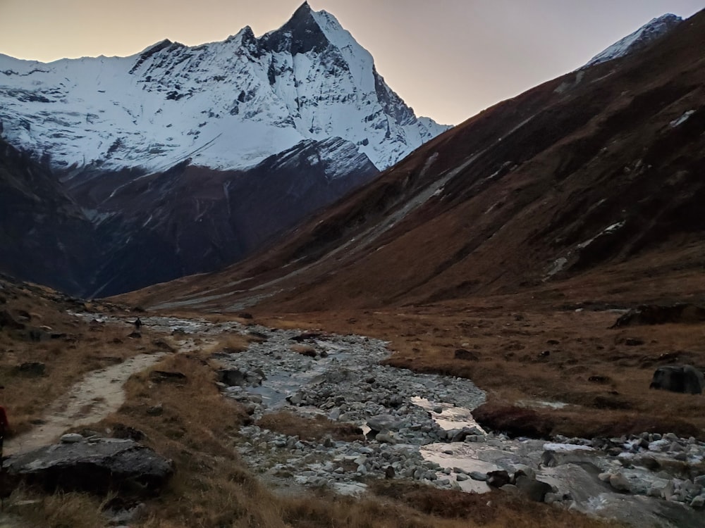 a person walking on a trail in the mountains