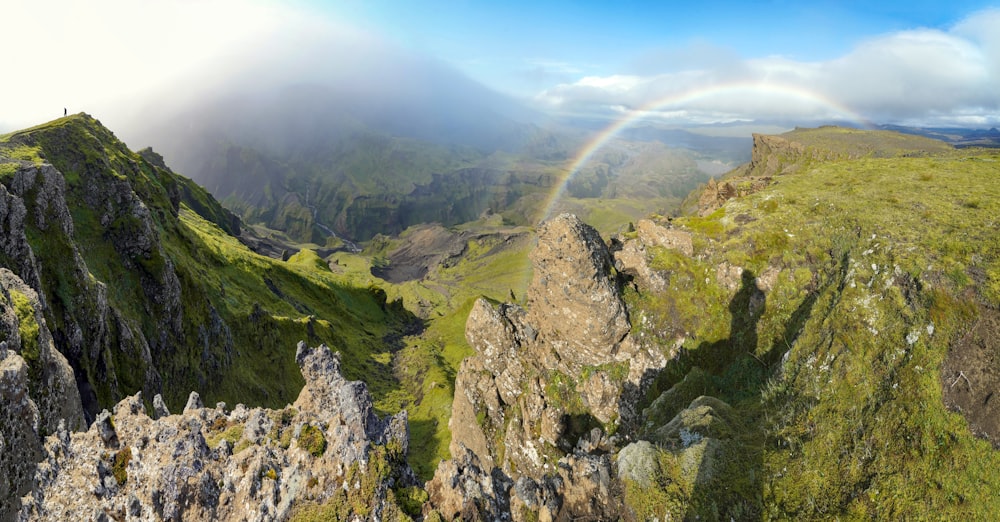 a rainbow in the sky over a mountain range