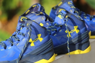 a pair of blue and yellow shoes on a ledge