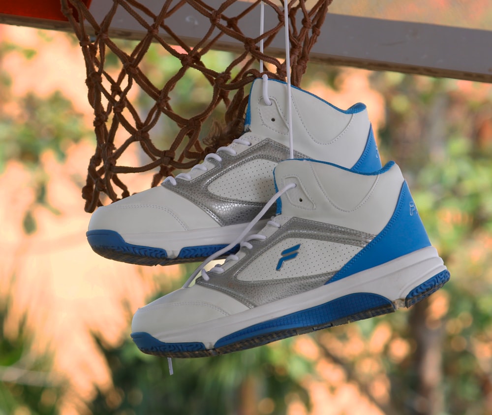a pair of shoes hanging from a basketball hoop