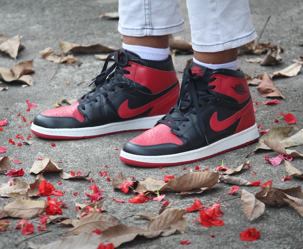 a pair of red and black sneakers on the ground