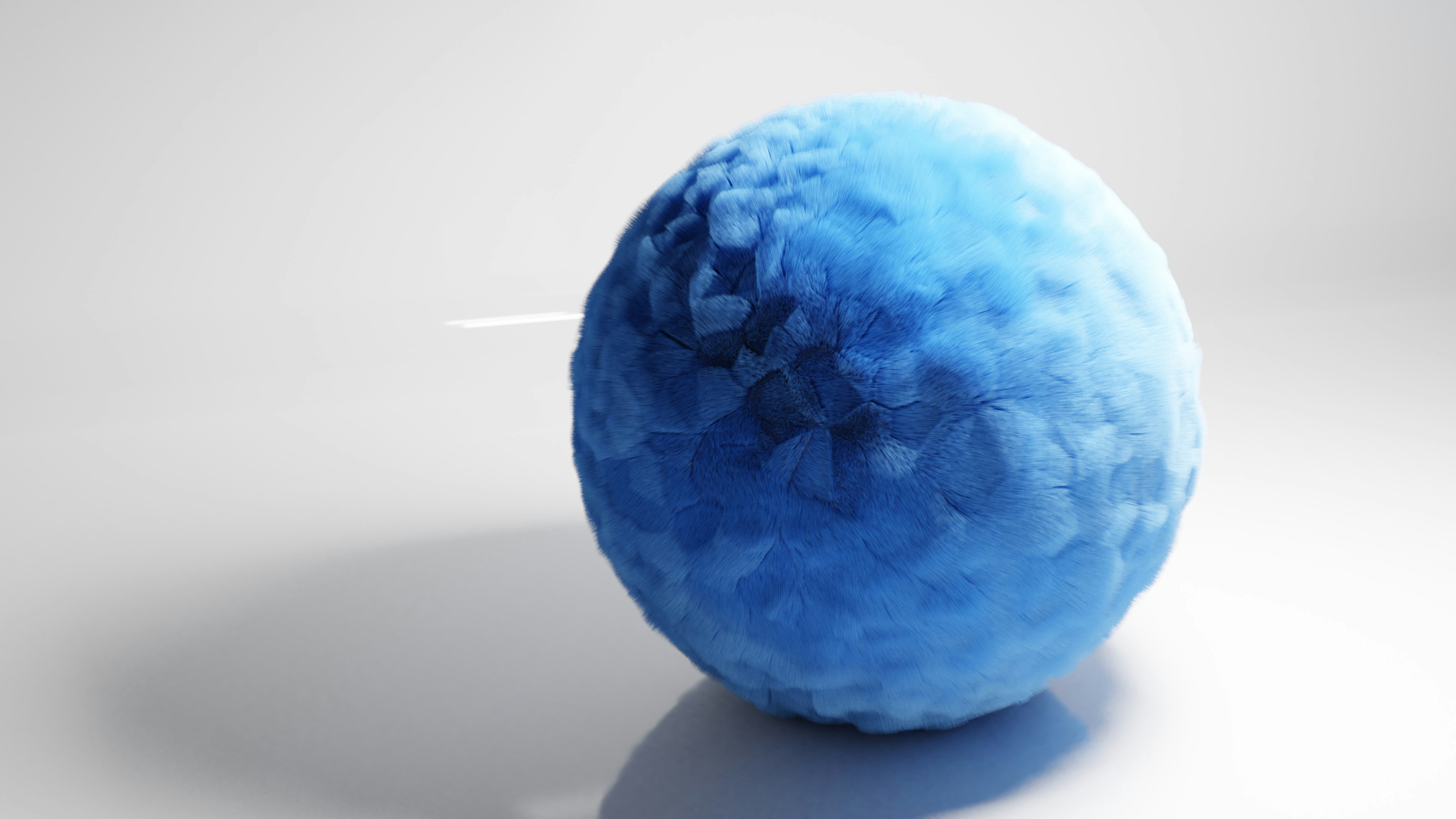 un objet bleu est assis sur une surface blanche