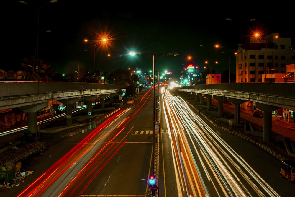 a city street filled with lots of traffic at night