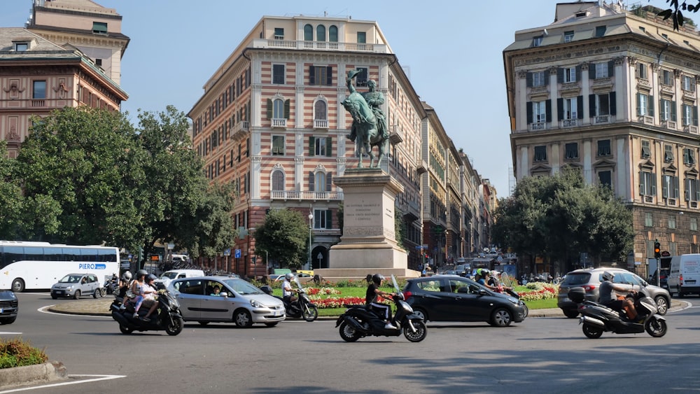 a group of motorcycles driving down a street next to tall buildings