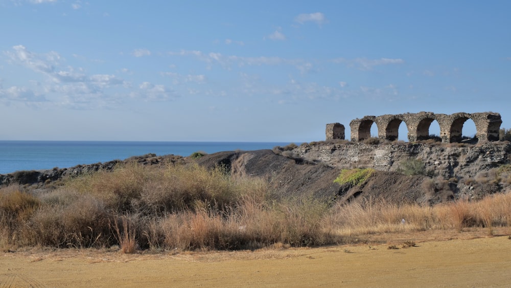 a large stone structure sitting on top of a dirt hill