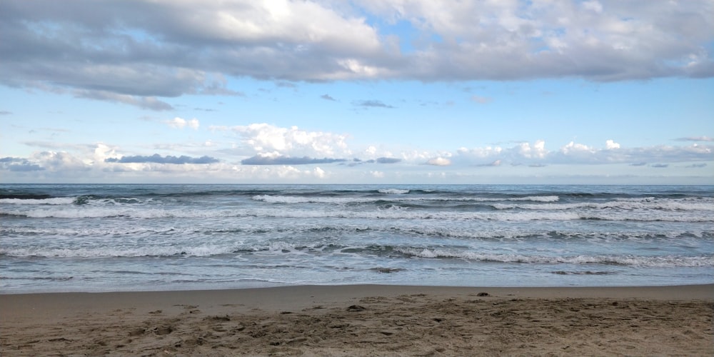 a view of the ocean from a sandy beach