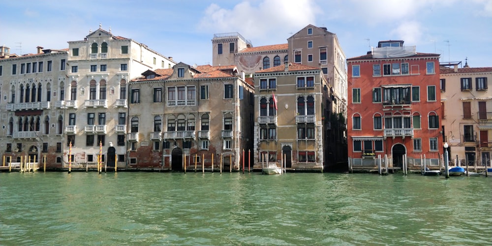 a row of buildings sitting next to a body of water