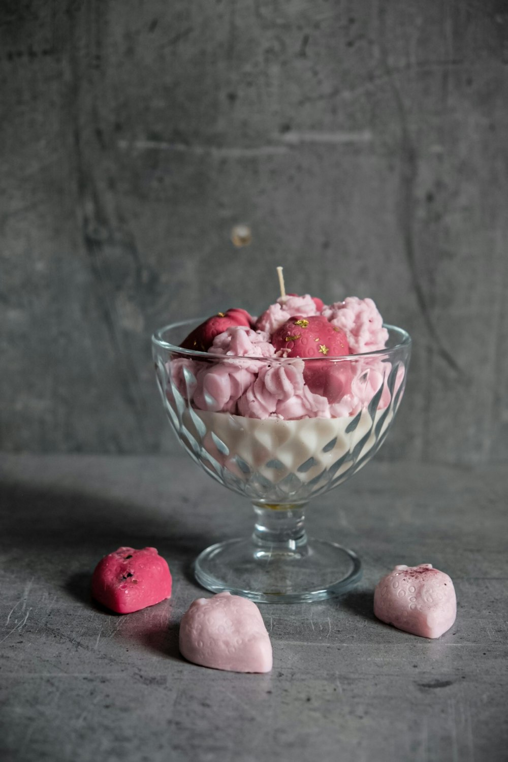 a glass bowl filled with pink and white dessert