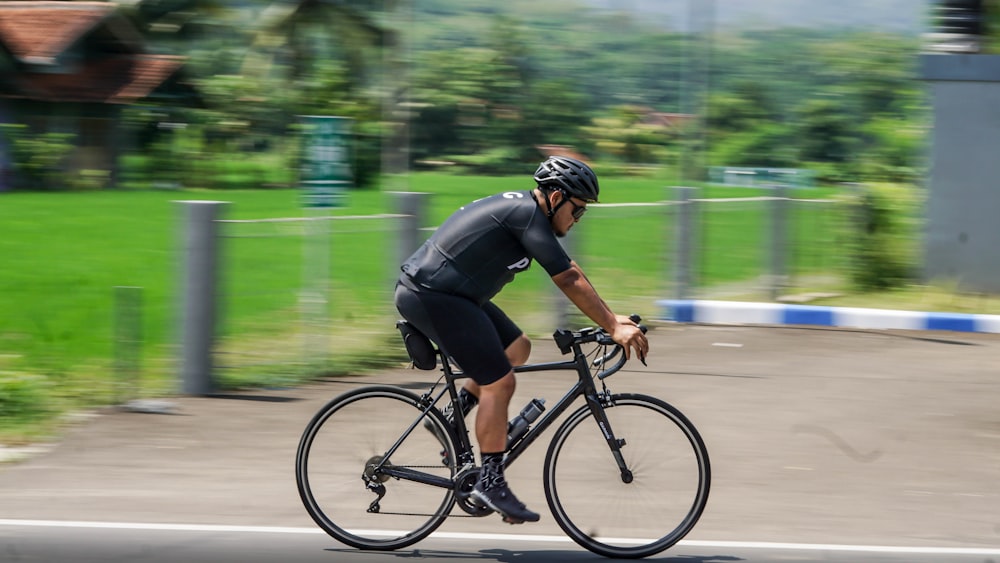 a man riding a bike down a street