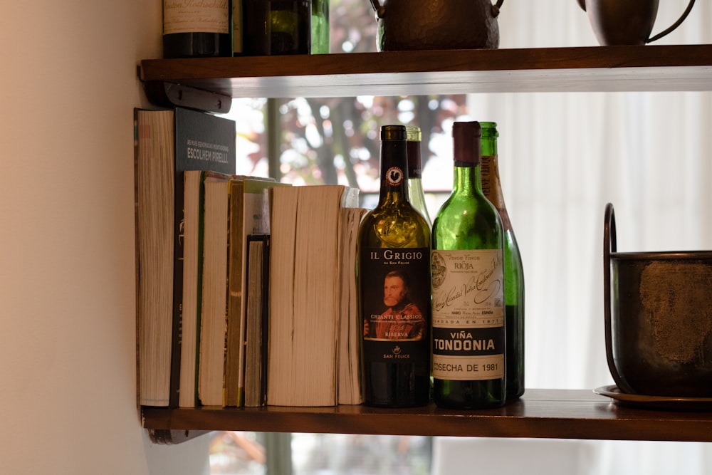 a couple of bottles of wine sitting on top of a wooden shelf