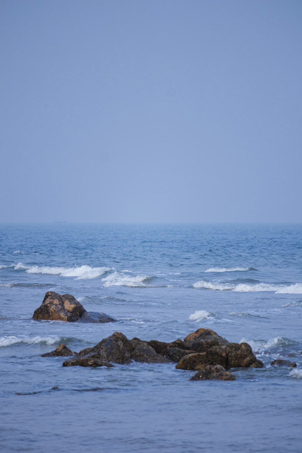 a person riding a surfboard on top of a wave in the ocean