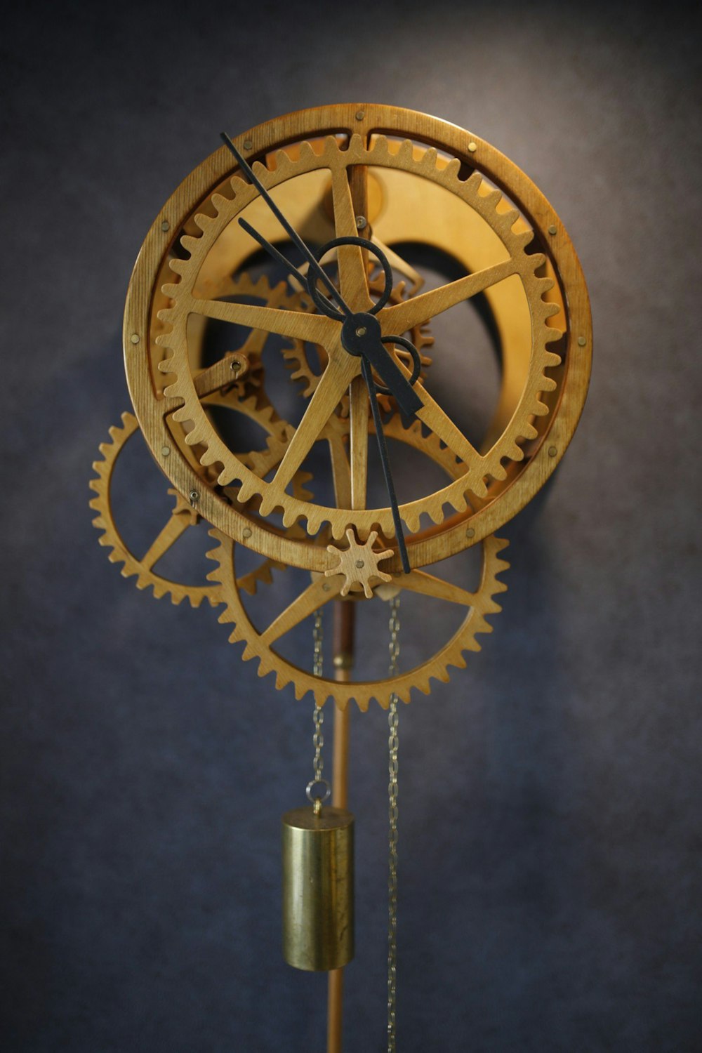 a golden clock with a chain attached to it