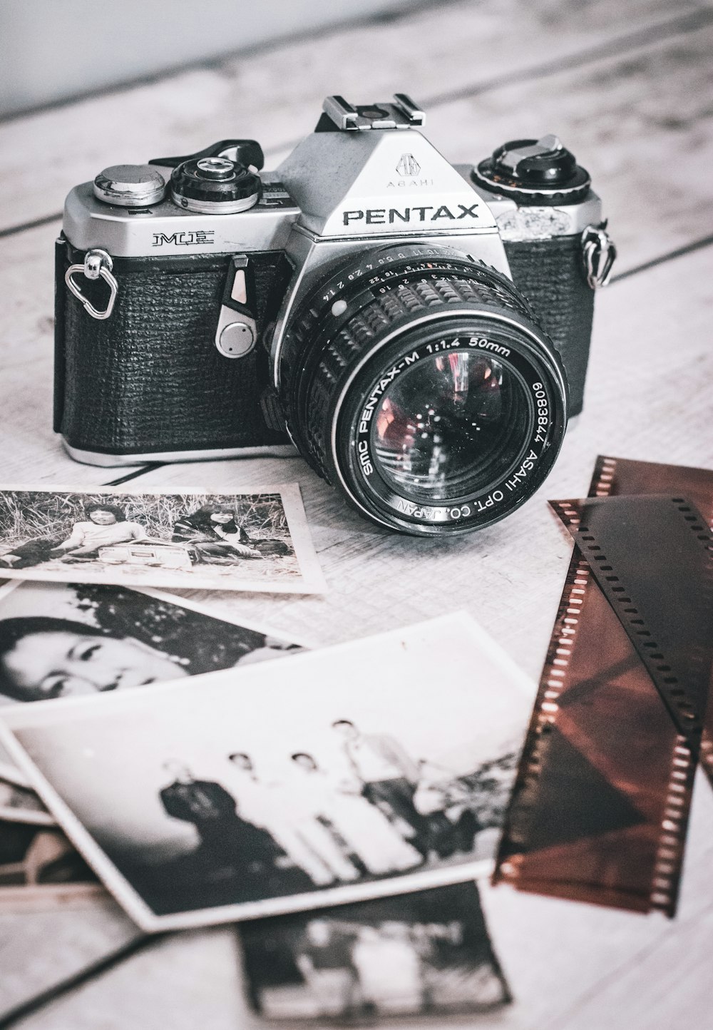 an old photo of a woman and a camera on a table