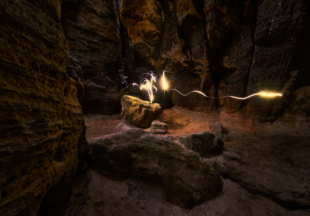 a person standing on a rock in a cave