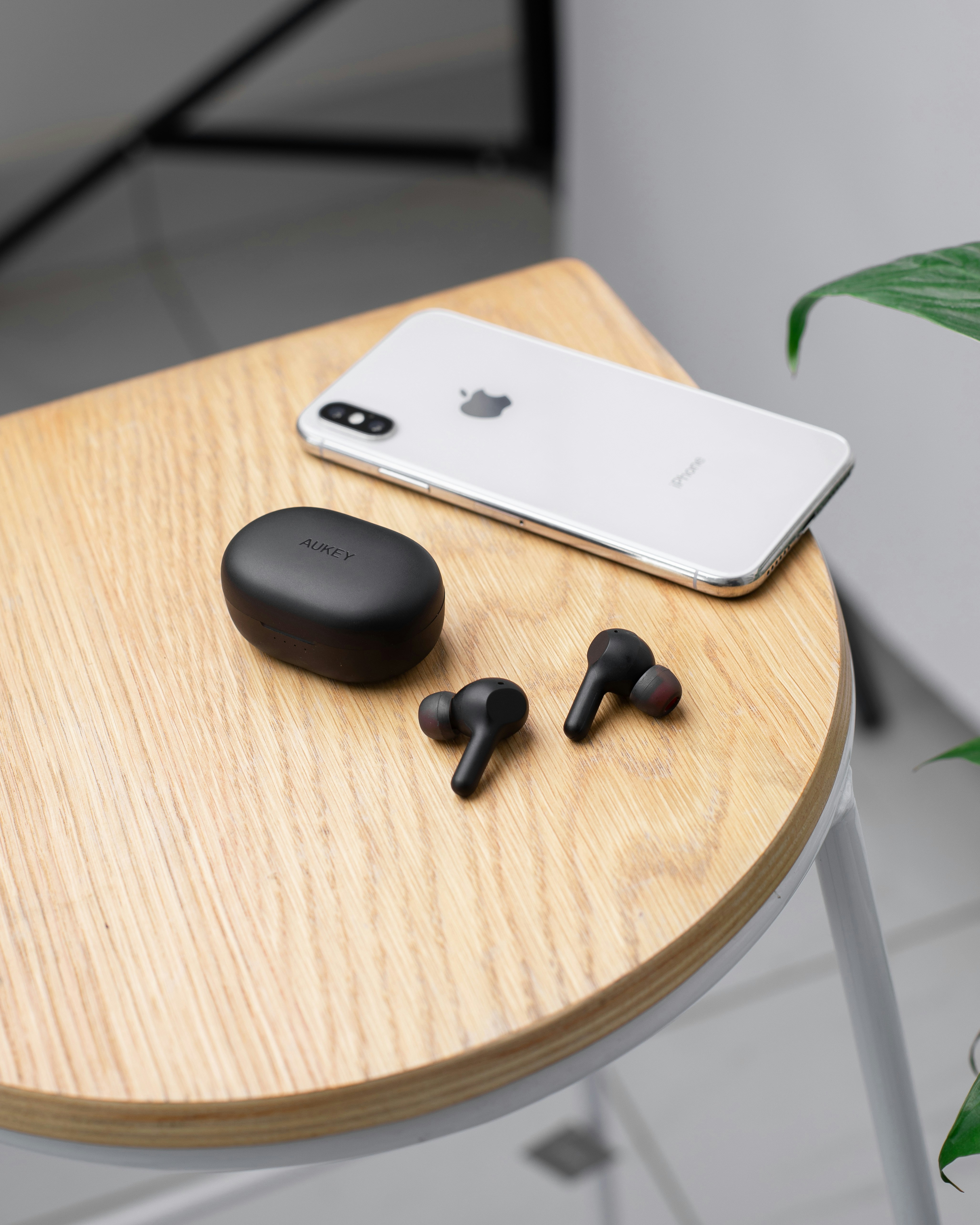 an iphone and ear buds sitting on a table