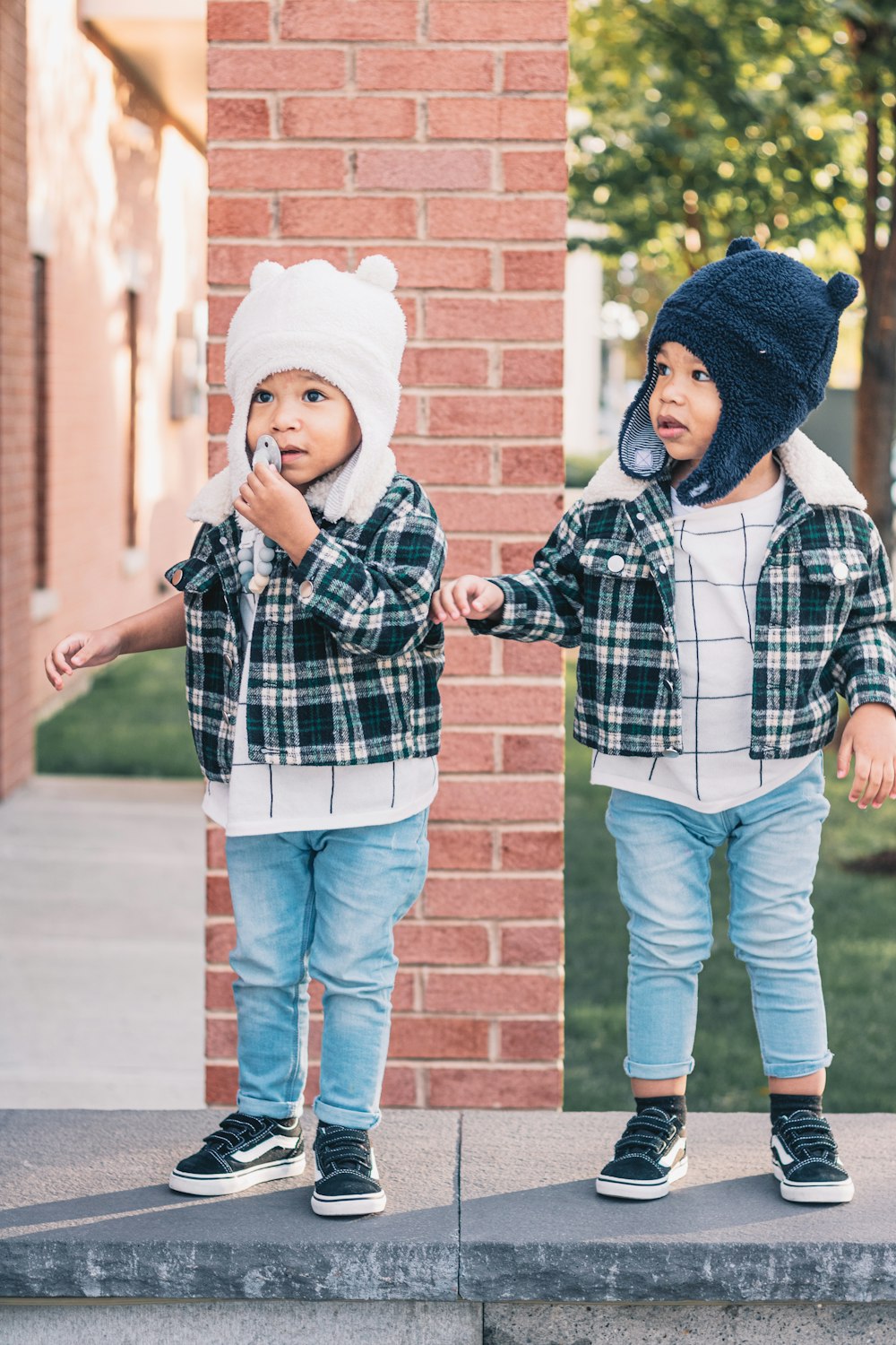 two young children standing on a step outside