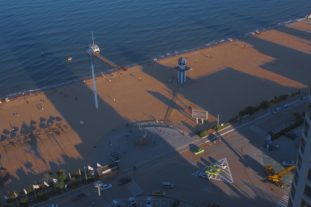 an aerial view of a beach with a clock tower in the distance