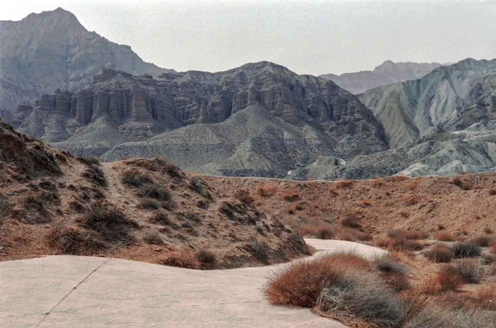 a man riding a skateboard down a dirt road