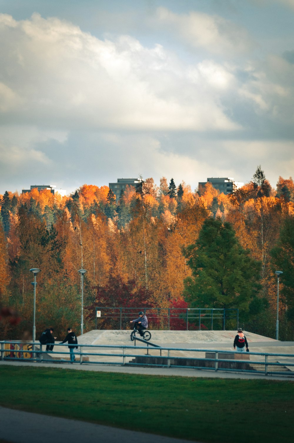 a group of people riding bikes around a skate park