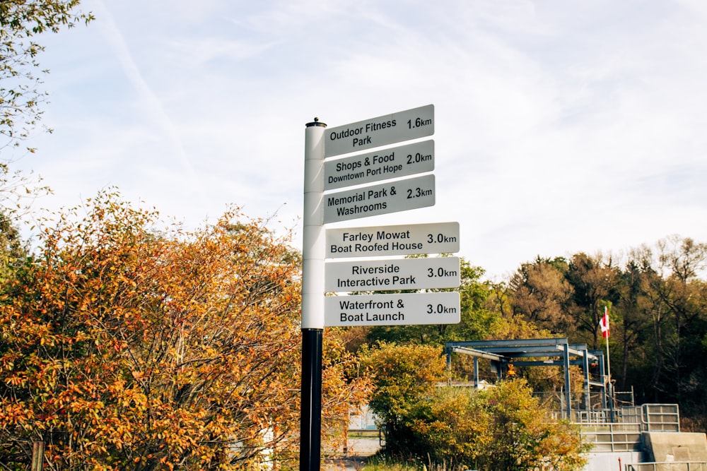 a white street sign sitting on the side of a road