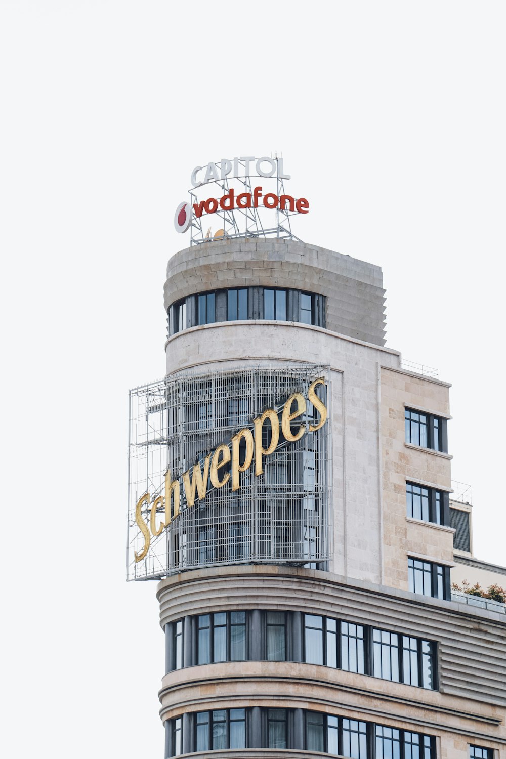 a tall building with a sign on top of it