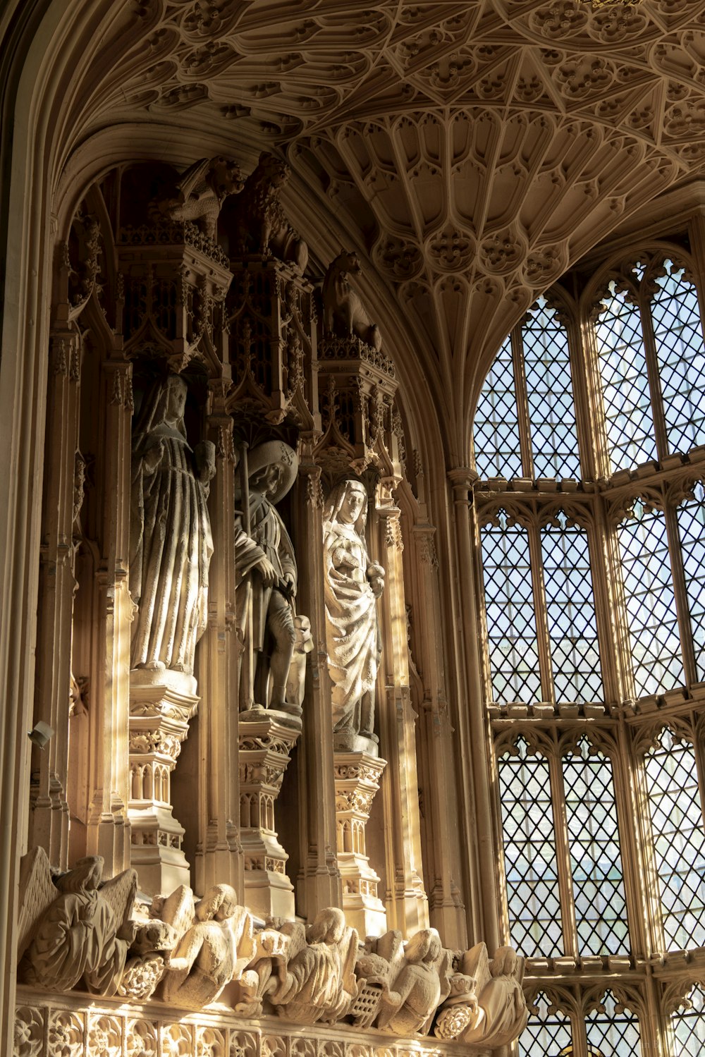 a statue of a man and a woman in front of a window