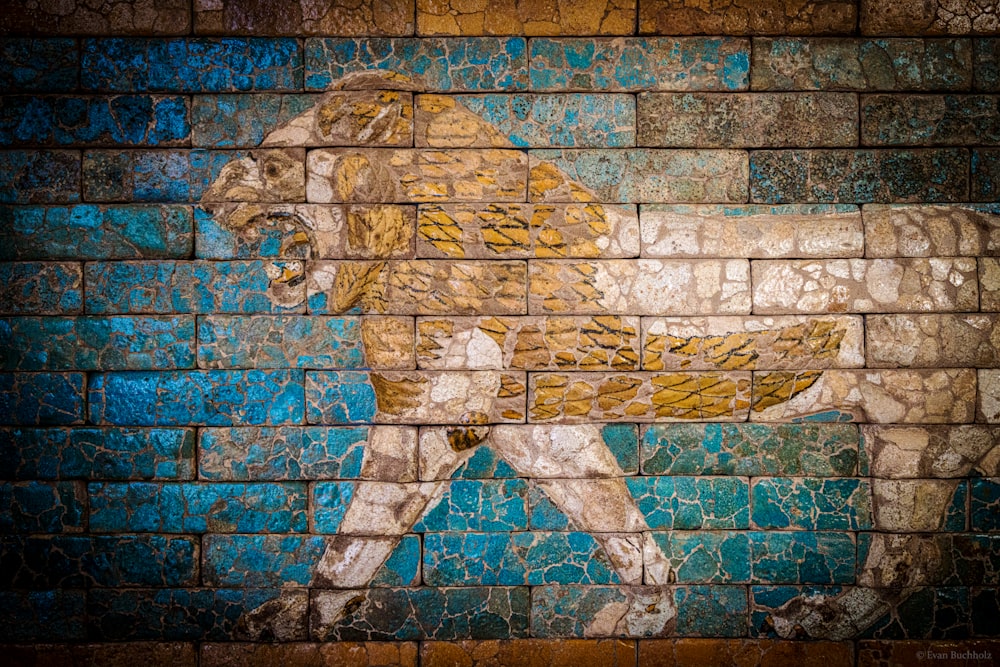 a painting of a lion on a brick wall