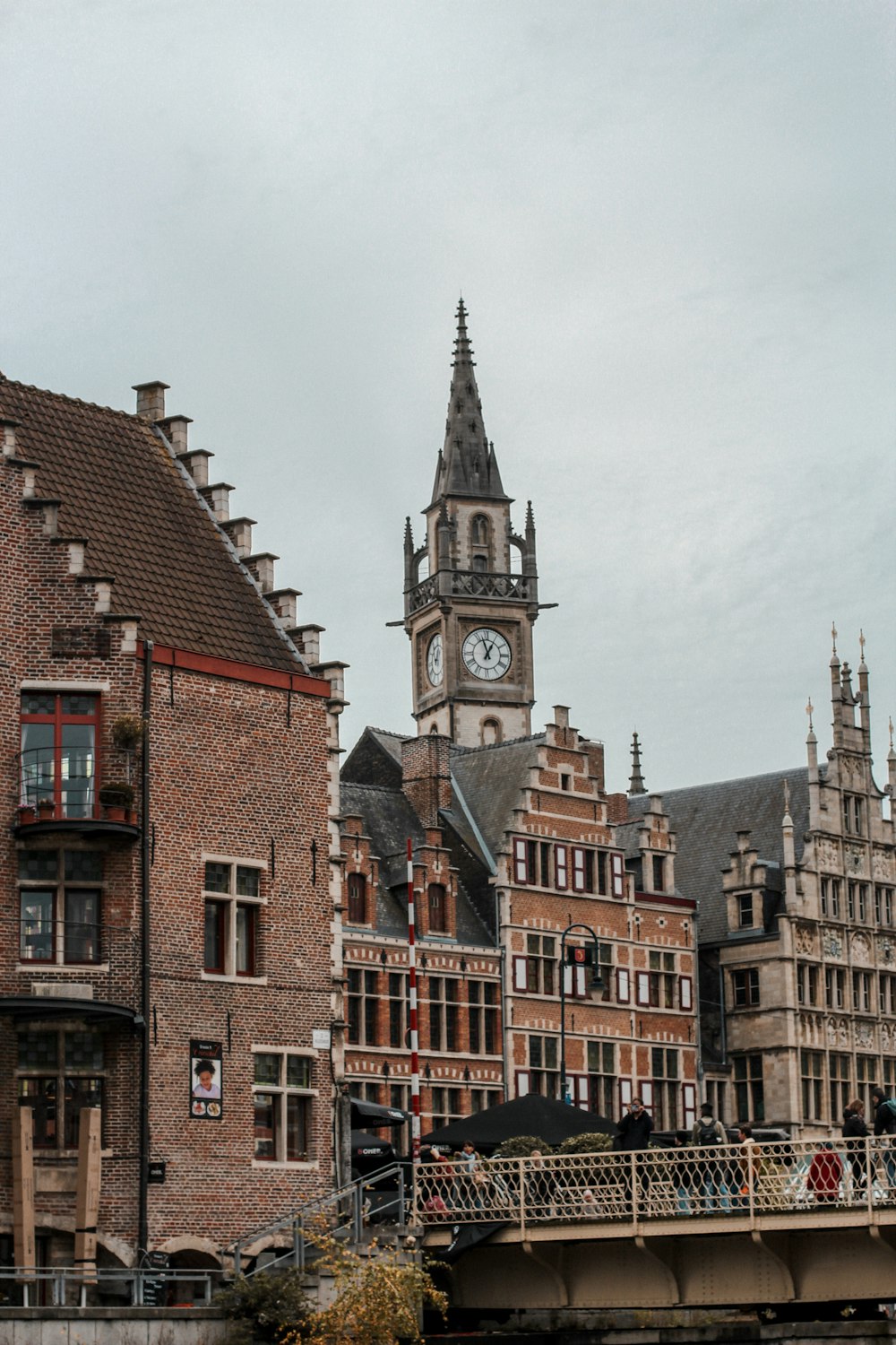 a bridge with a clock tower in the background