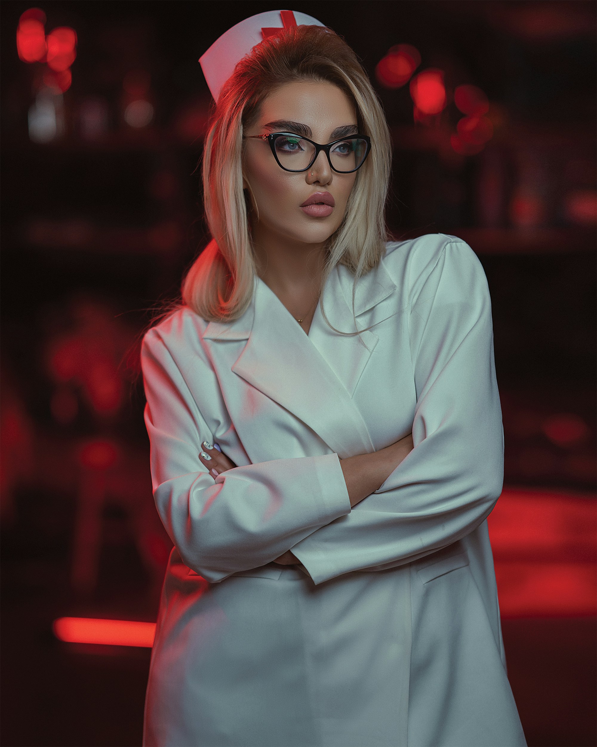 a woman wearing a white coat and glasses