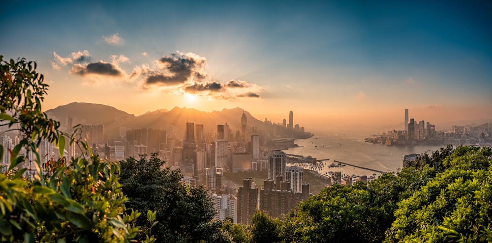 the sun is setting over the city of hong