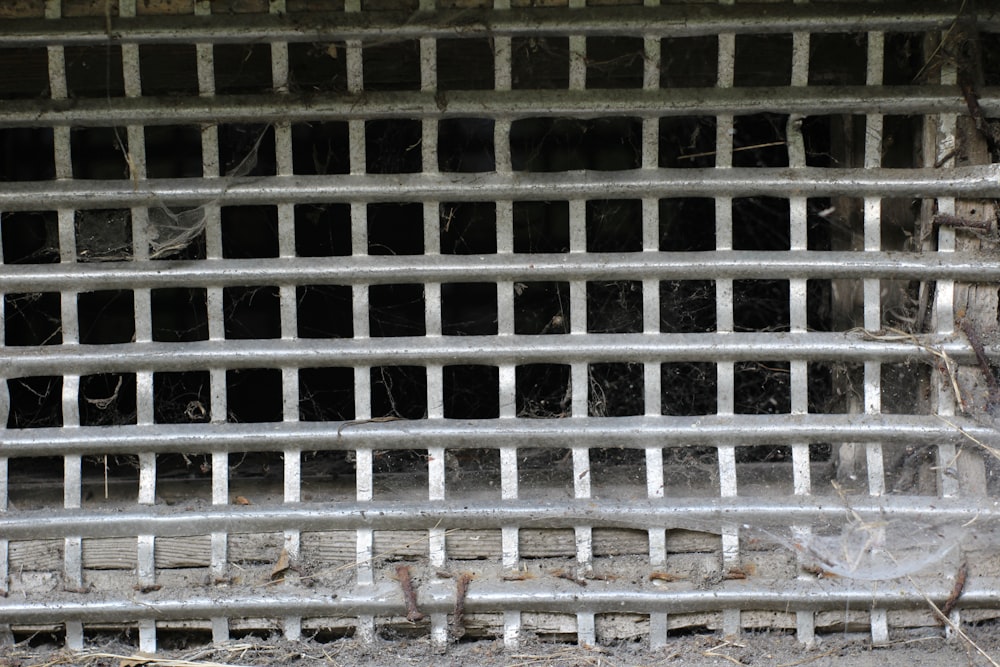 a close up of a metal grate on the ground