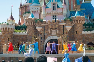 a group of people standing on top of a stage in front of a castle
