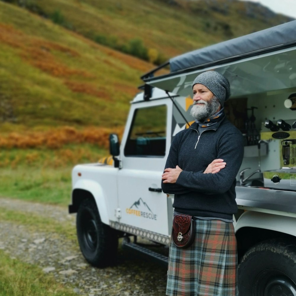 a man standing in front of a white truck