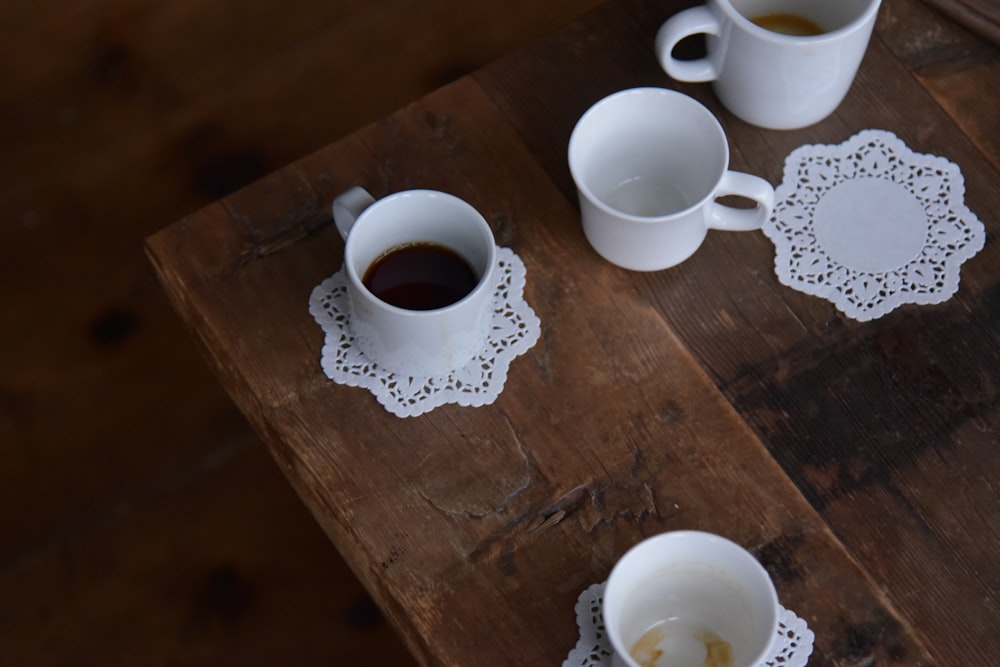 three cups of coffee on a wooden table
