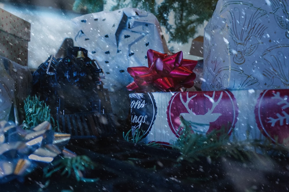 a pile of wrapped presents sitting on top of a table