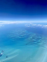 The rich blue tones of the Caribbean sea merging with the sky, highlighting the vast fishing grounds.