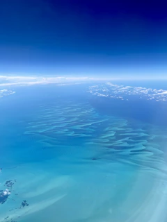 The rich blue tones of the Caribbean sea merging with the sky, highlighting the vast fishing grounds.