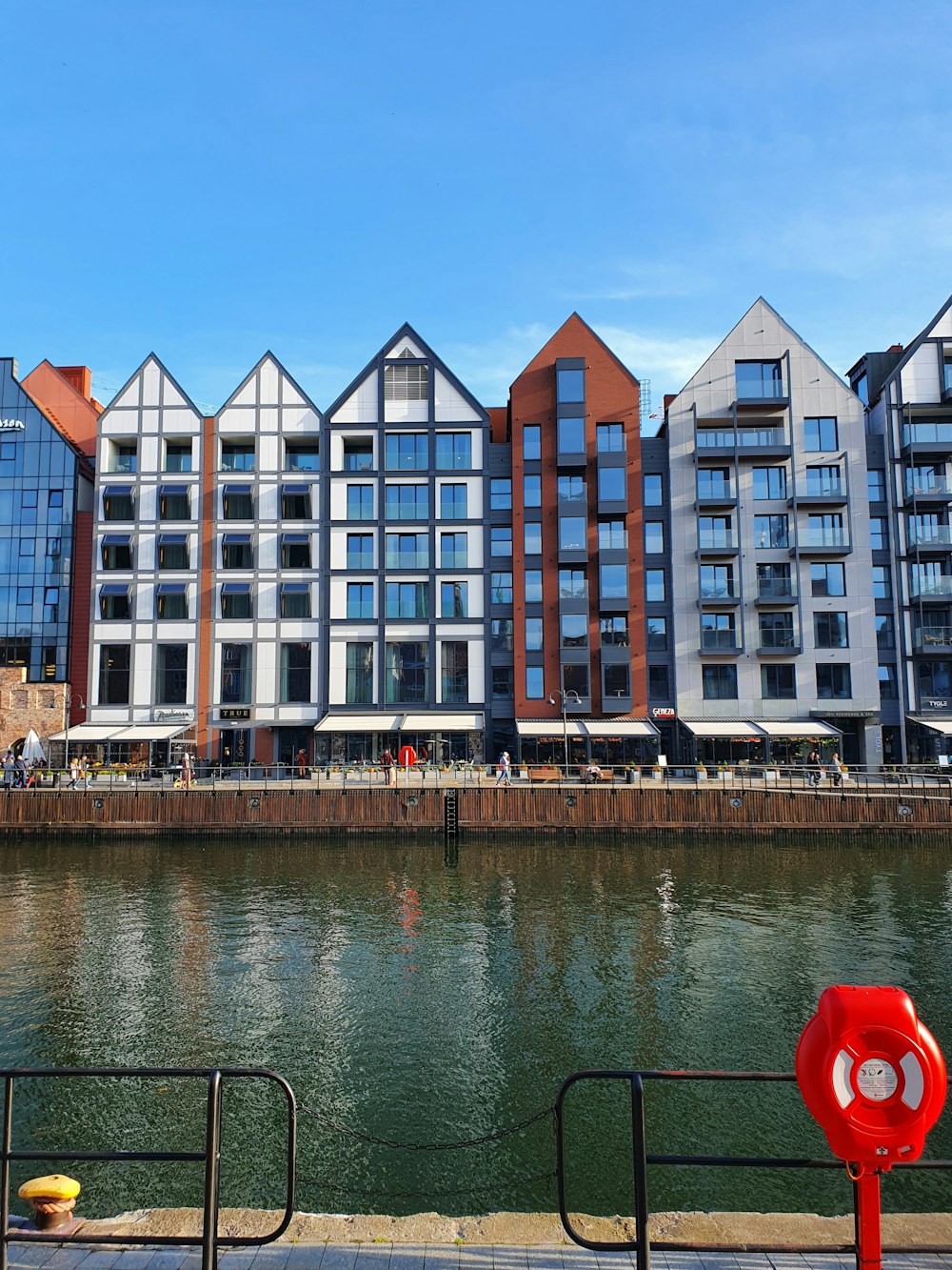 a row of buildings next to a body of water