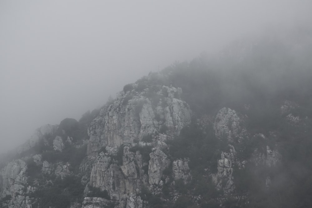 a mountain covered in fog and low lying clouds