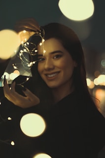 A candid photo of babyjade06 laughing under soft pink fairy lights