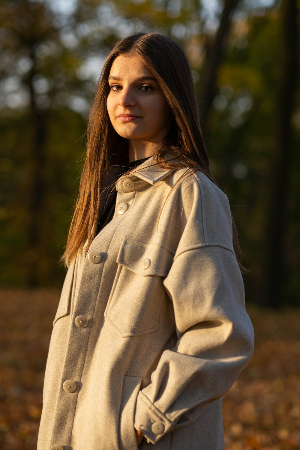 a woman standing in a field of leaves