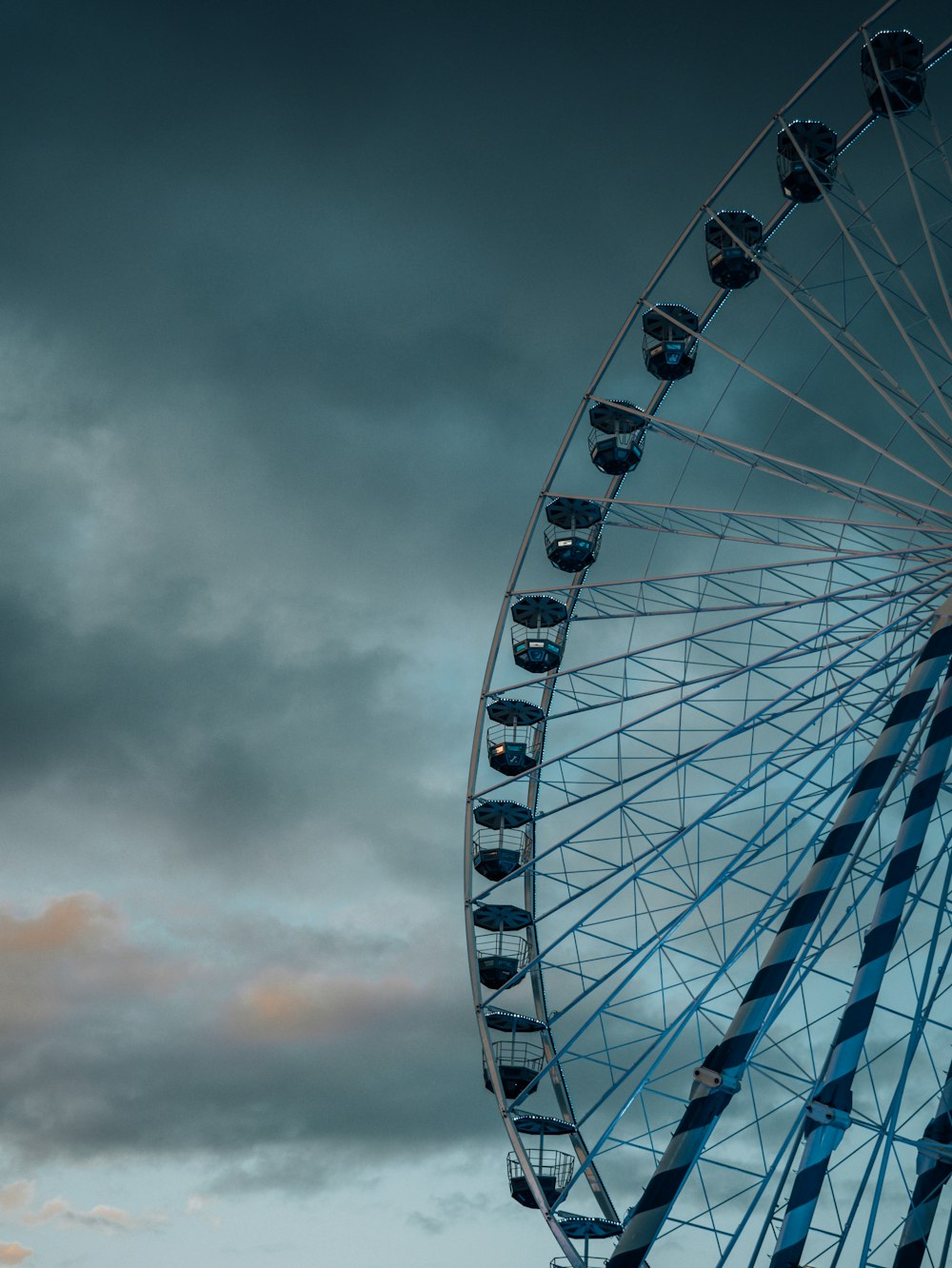 a large ferris wheel sitting under a cloudy sky