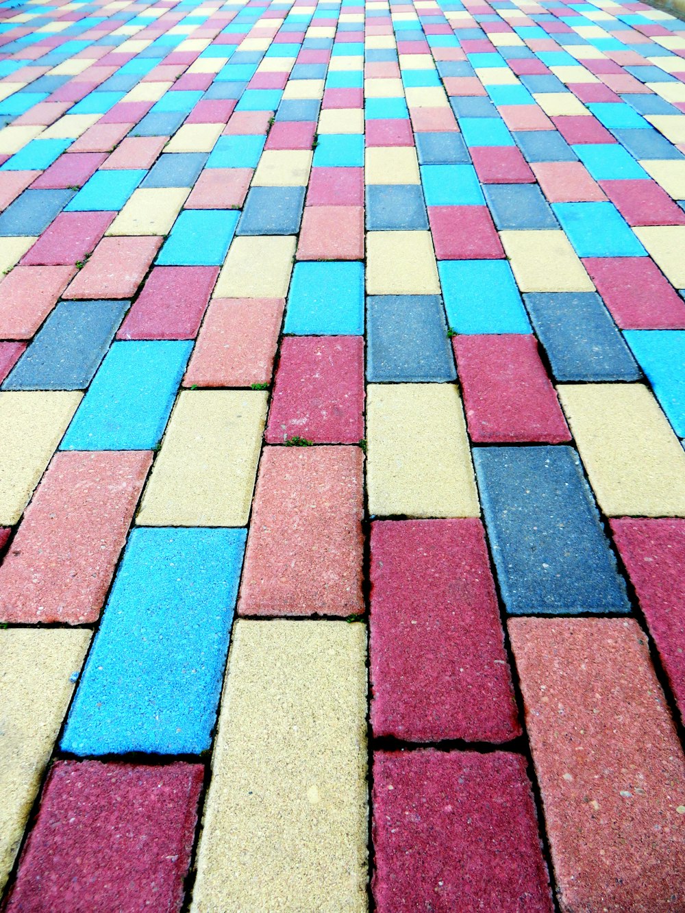 a close up of a colorful brick sidewalk