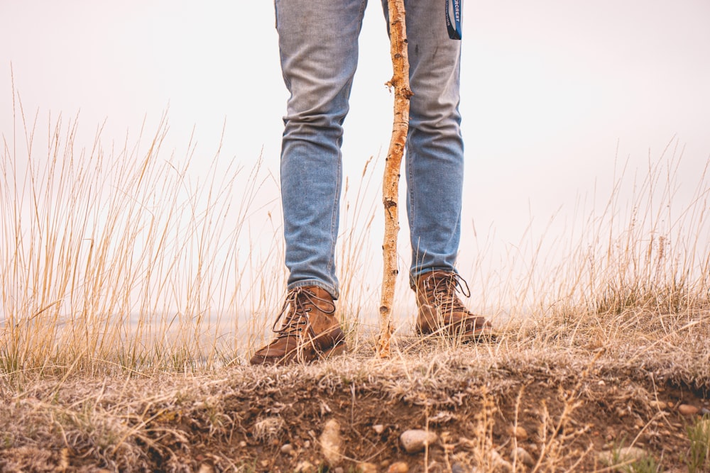 a person standing on top of a dry grass covered field