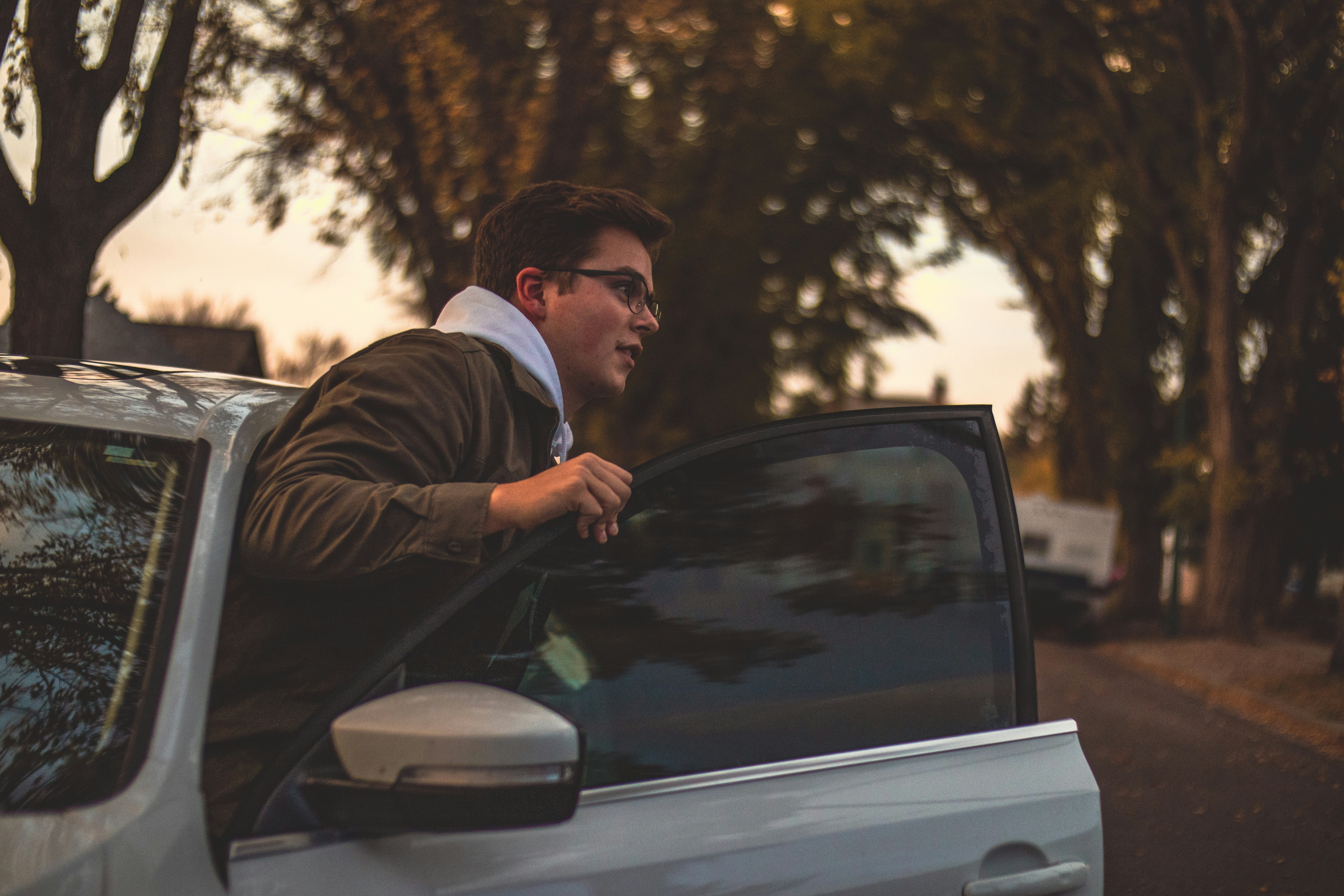 a man leaning out the window of a car