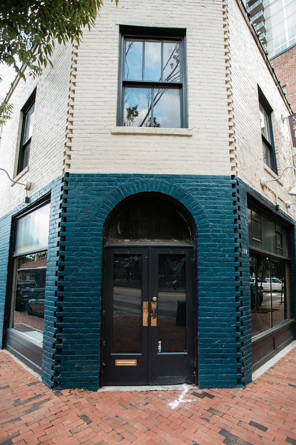 a brick building with a black door and windows