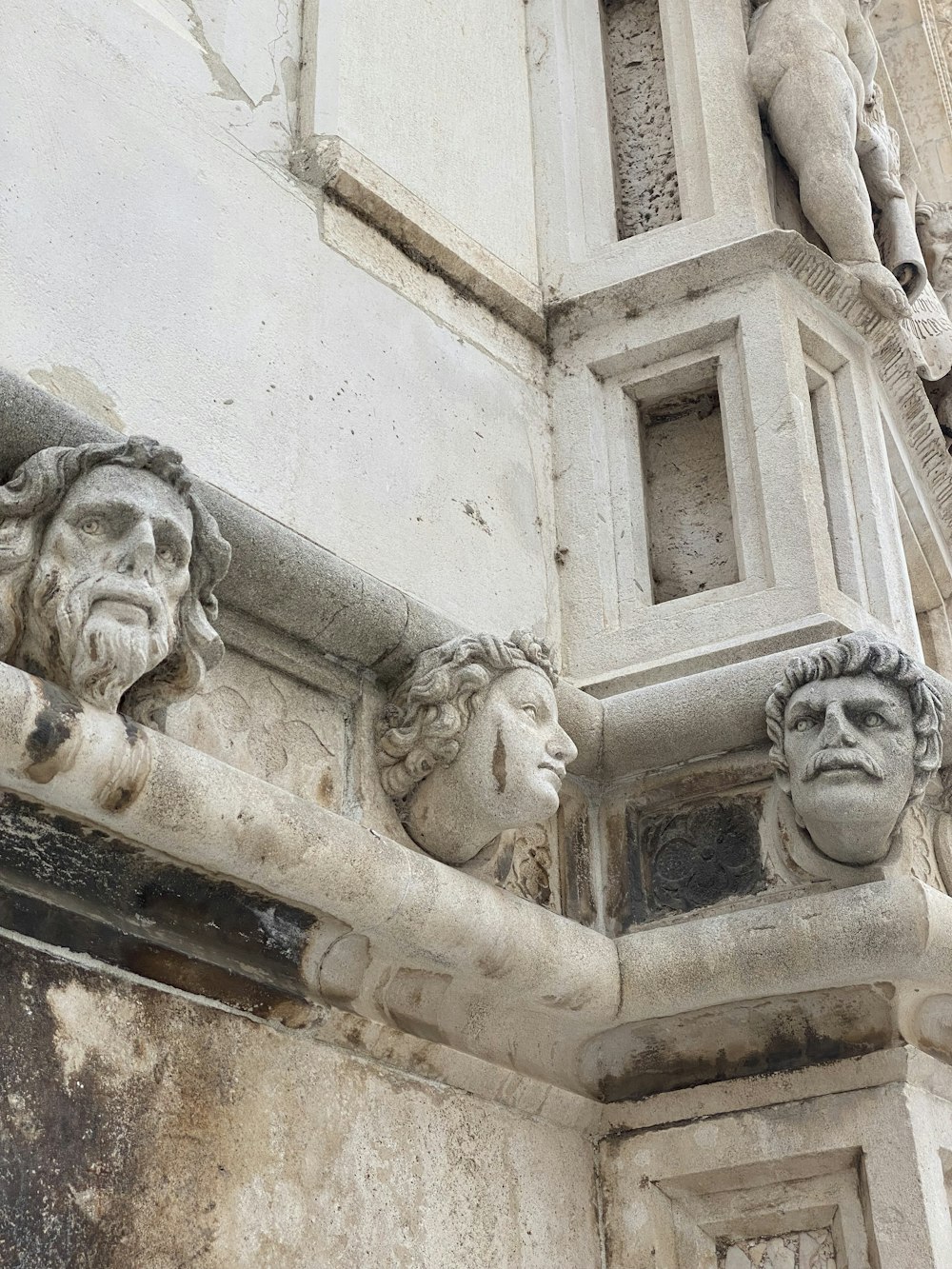 a close up of some statues on a building