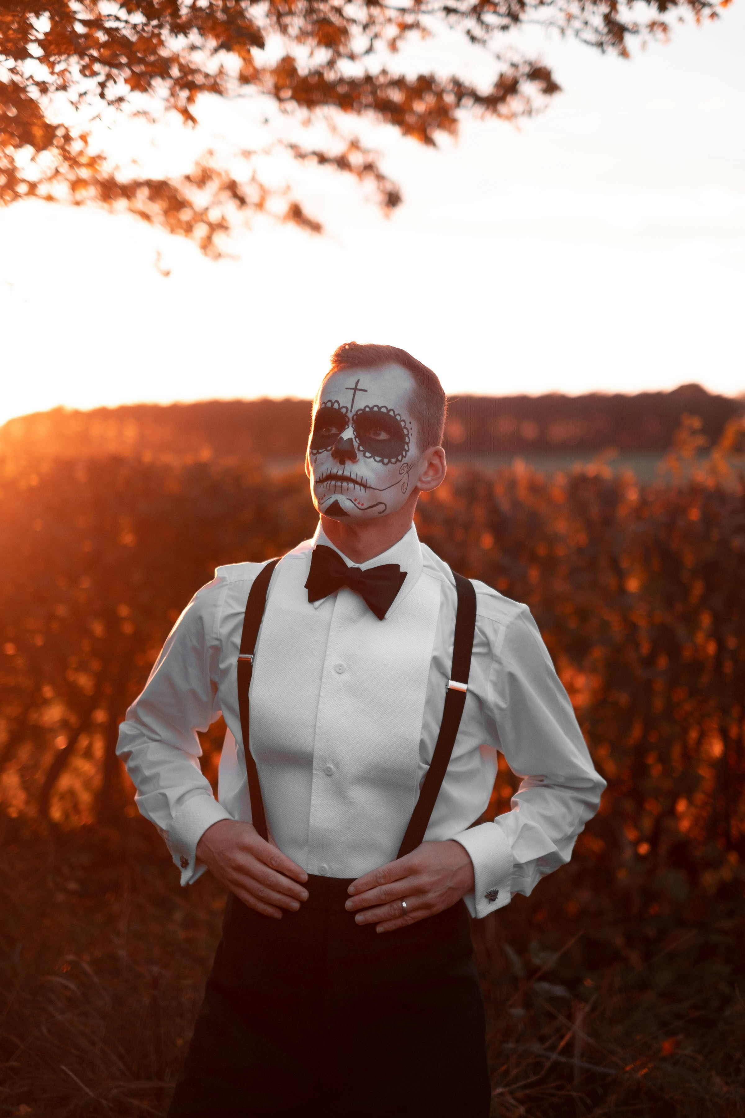 a man wearing a skeleton mask and bow tie